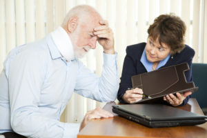 A financial advisor explains to an injured man about the terms of his settlement.