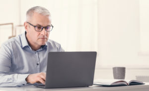 older man doing internet research