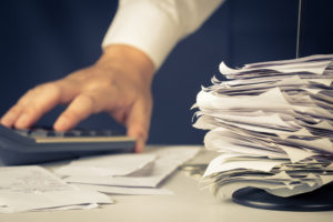 close-up on person doing bills