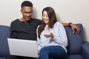 a young couple paying bills online