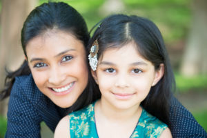 closeup of smiling mother and daughter