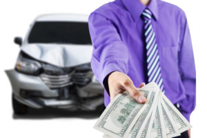 lender giving money with wrecked car in background