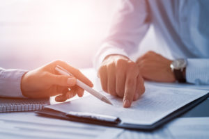 businesspeople signing loan paperwork