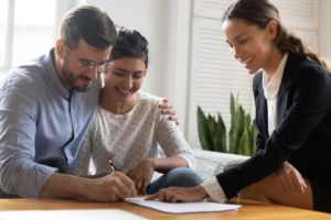 happy couple signing for a loan