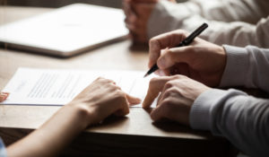 person signing loan paperwork