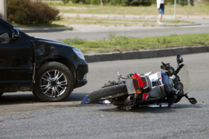 crash with car and motorcycle on the road