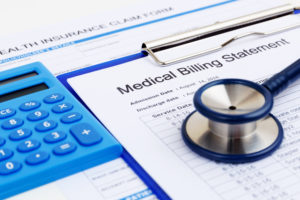 medical bills with stethoscope