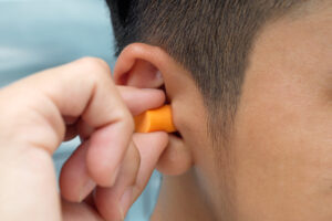 man putting in earplugs