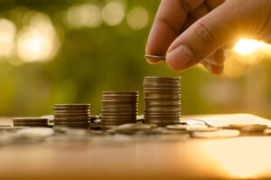 person stacking coins