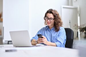 woman happily checking bank account on computer