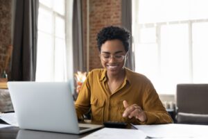 woman happily doing her budget