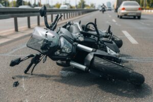 A crashed motorcycle on the side of the road. How to pay for medical treatment after a motorcycle accident.