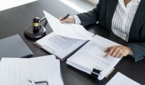 A lawyer at her desk, looking over papers.