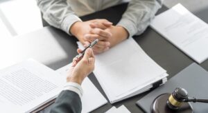 A client receiving a pen, dropping their lawyer before a settlement